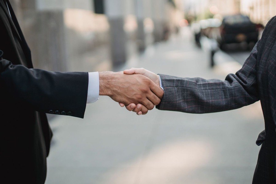 Two people shaking hands to confirm a solar farm match